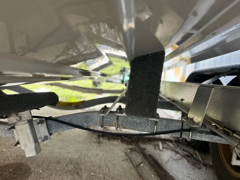 Slide: The Image of Underneath view of a 2020 Aquasport 244 Bay boat on a trailer. - 13