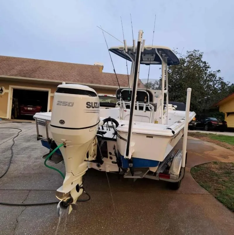 Slide: The Image of 2020 Aquasport 244 Bay boat with Suzuki 250 outboard motor in driveway. - 15