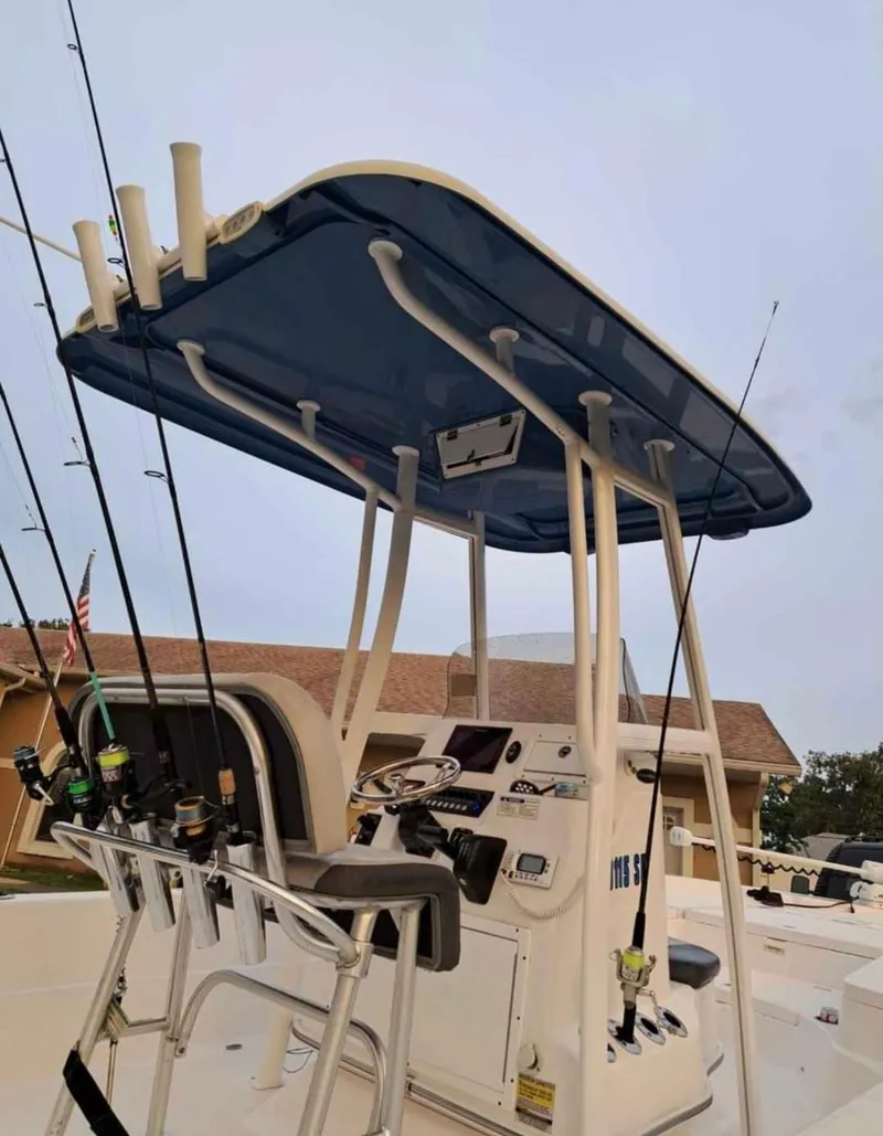 Slide: The Image of 2020 Aquasport 244 Bay boat with fishing rods and T-top. - 16