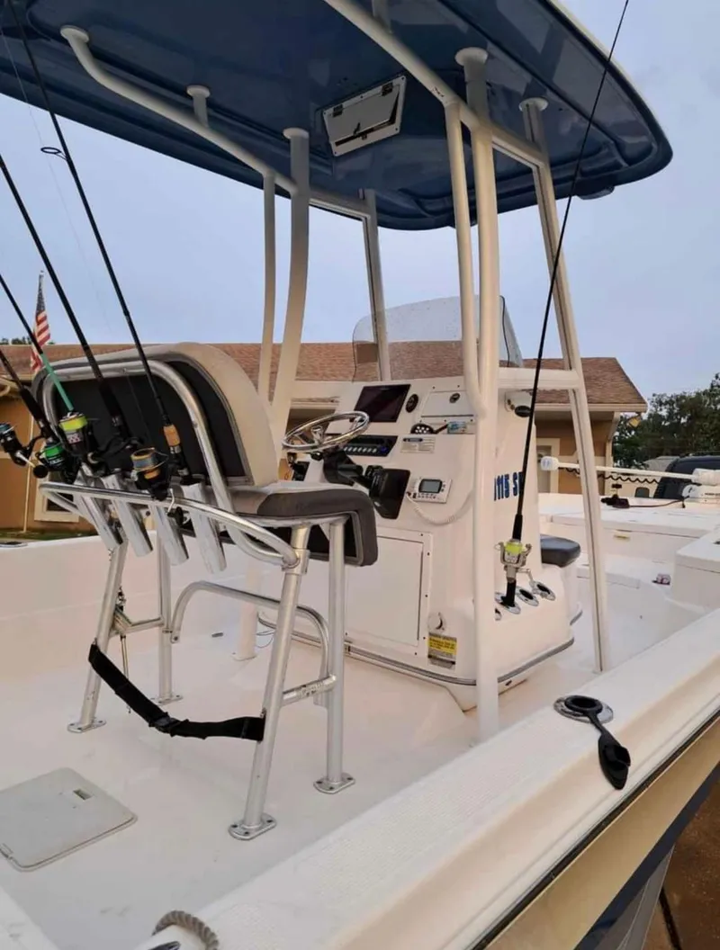 Slide: The Image of 2020 Aquasport 244 Bay boat with fishing rods and center console. - 17