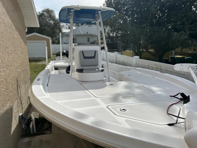 Slide: The Image of 2020 Aquasport 244 Bay boat with T-top and center console in a residential backyard. - 19