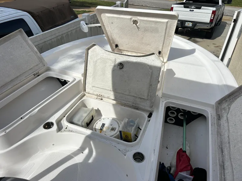 Slide: The Image of 2020 Aquasport 244 Bay boat with open storage compartments. - 24