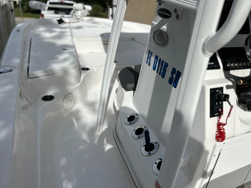 Slide: The Image of 2020 Aquasport 244 Bay boat interior with control panel and seating area. - 29