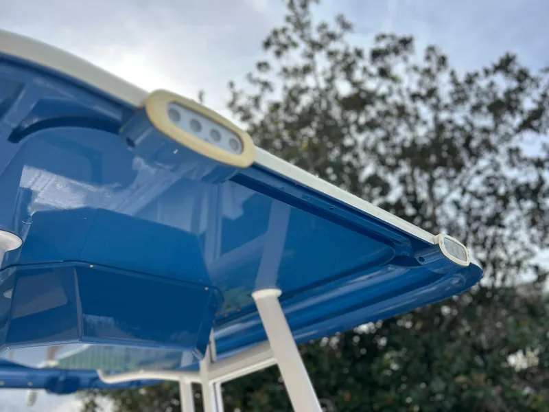 Slide: The Image of Close-up of 2020 Aquasport 244 Bay boat's blue canopy. - 33