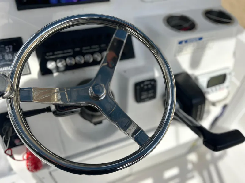 Slide: The Image of Close-up of 2020 Aquasport 244 Bay boat steering wheel and controls. - 34