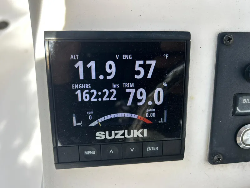 Slide: The Image of Suzuki engine display on 2020 Aquasport 244 Bay showing engine hours and trim. - 37