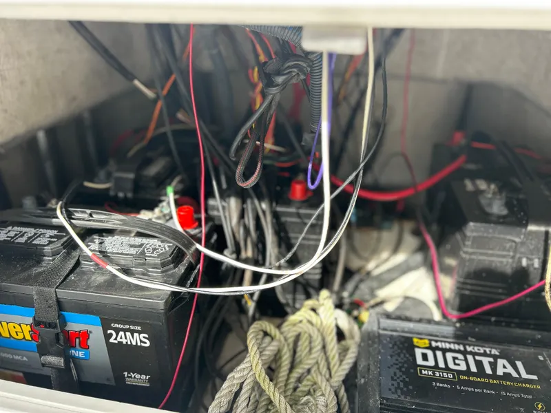 Slide: The Image of Battery compartment of a 2020 Aquasport 244 Bay boat with wiring and ropes. - 41