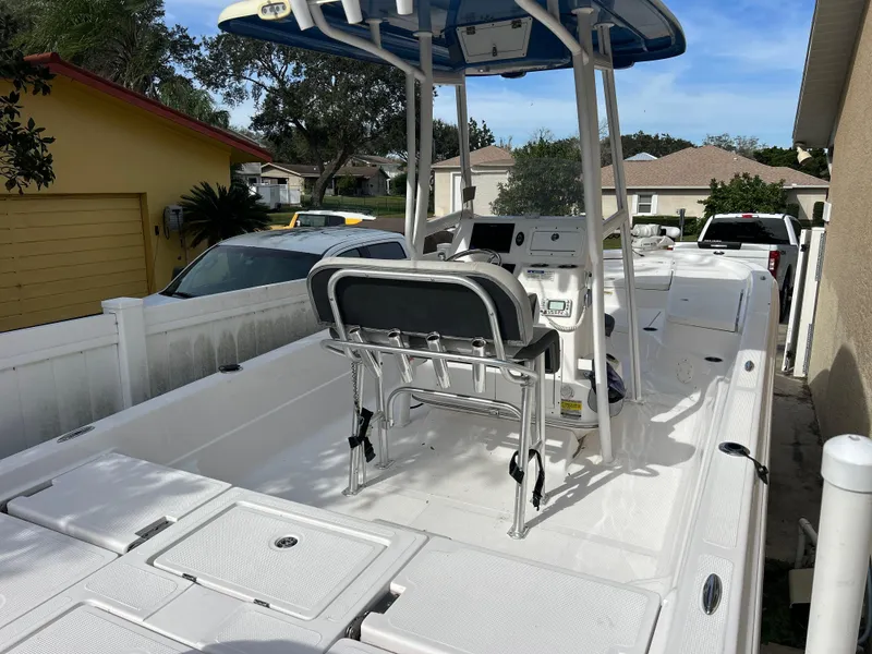 Slide: The Image of 2020 Aquasport 244 Bay boat with center console and seating, parked in a residential driveway. - 42