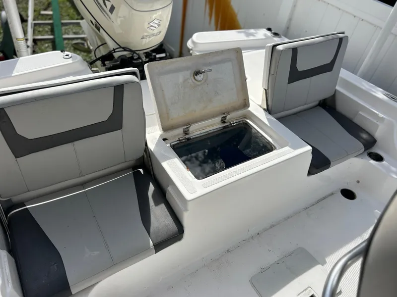 Slide: The Image of 2020 Aquasport 244 Bay boat seating and storage compartment. - 44