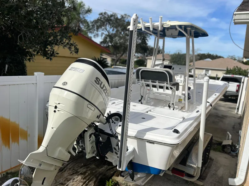 Slide: The Image of 2020 Aquasport 244 Bay boat with Suzuki outboard motor in driveway. - 45