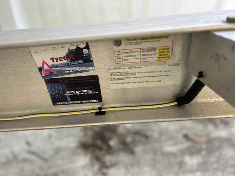 Slide: The Image of 2020 Aquasport 244 Bay trailer label with tire and loading information. - 47