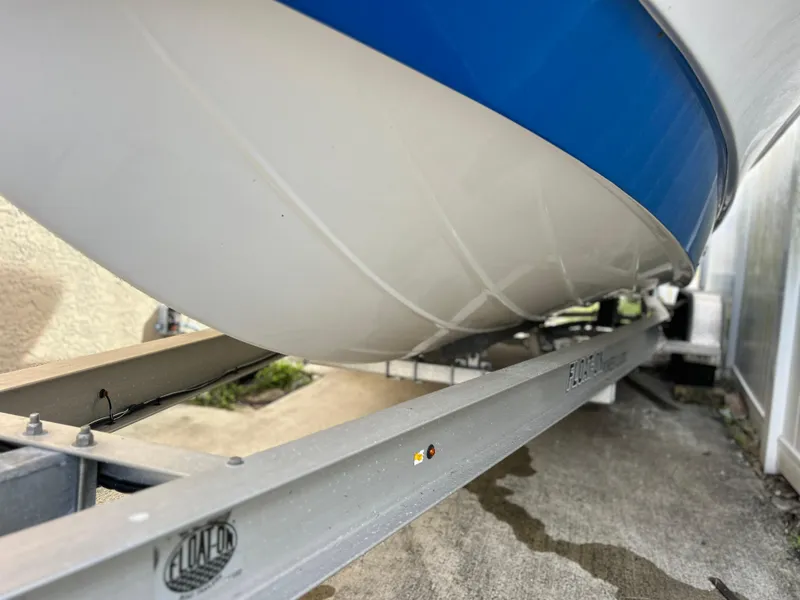 Slide: The Image of 2020 Aquasport 244 Bay boat on a trailer, close-up view of the hull. - 7