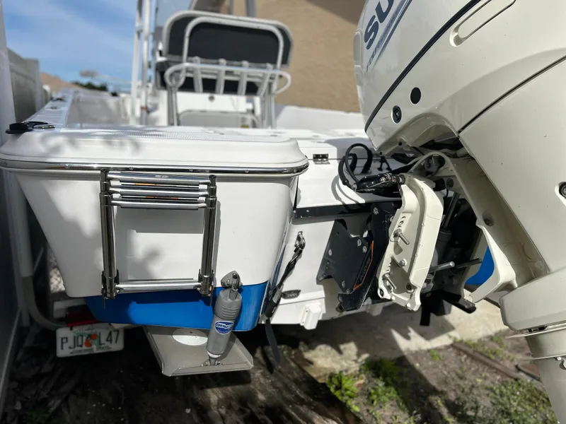 Slide: The Image of 2020 Aquasport 244 Bay boat with Suzuki outboard motor and swim ladder. - 9