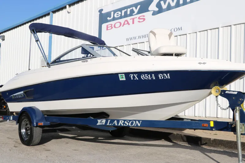 Slide: The Image of 2011 Larson LX850 Classic SF boat on trailer outside dealership. - 11