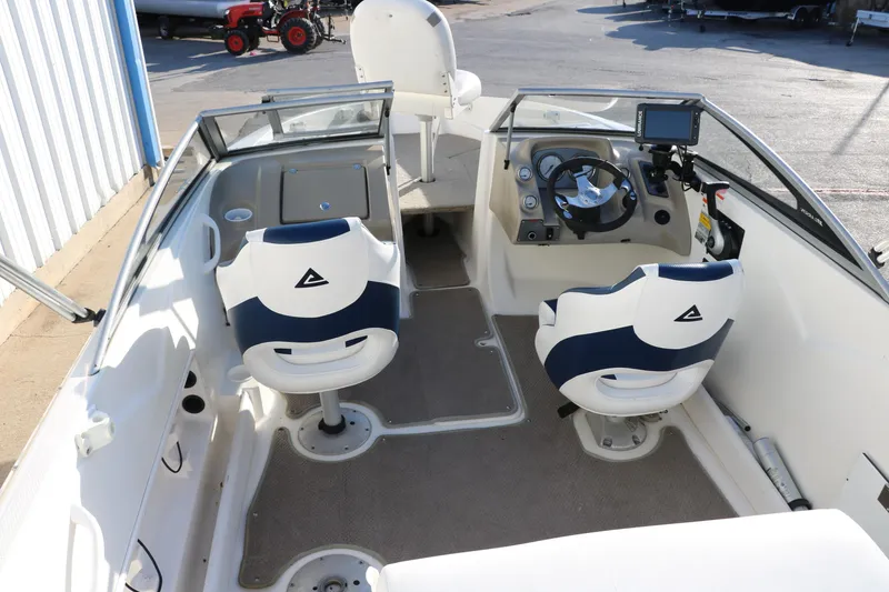 Slide: The Image of Interior of a 2011 Larson LX850 Classic SF boat with dual swivel seats and steering console. - 16