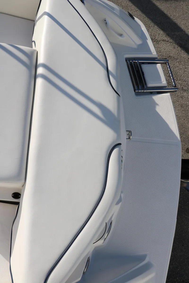 Slide: The Image of 2011 Larson LX850 Classic SF boat with white cushioned seating. - 19