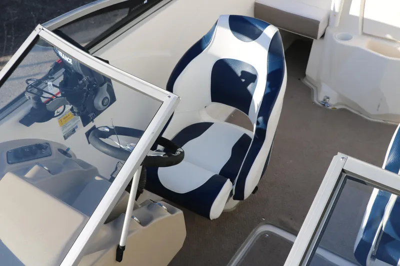 Slide: The Image of 2011 Larson LX850 Classic SF boat interior with captain's chair and steering wheel. - 25