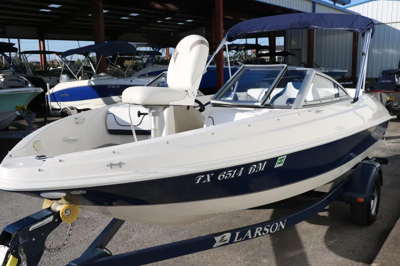 Slide: The Image of 2011 Larson LX850 Classic SF boat on trailer in marina. - 8