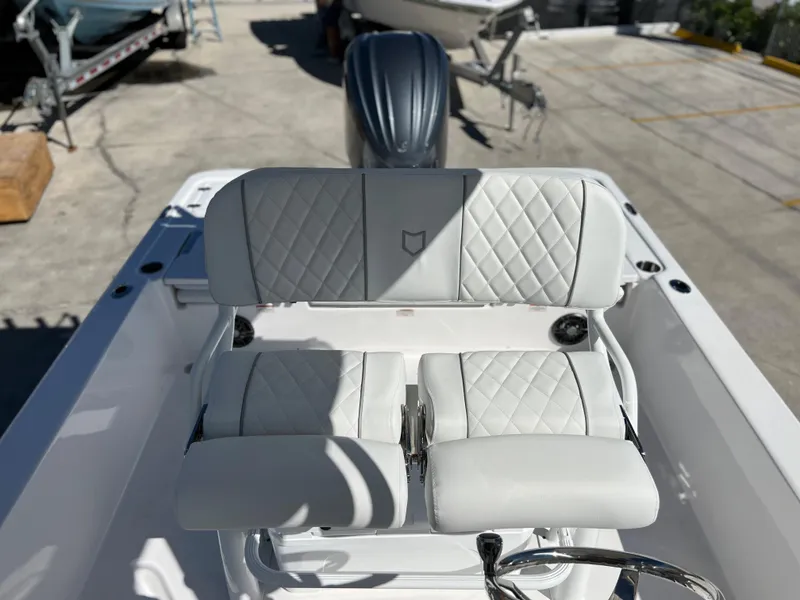 Slide: The Image of 2024 Sea Fox 251 Bay Fox boat interior with white cushioned seating. - 19
