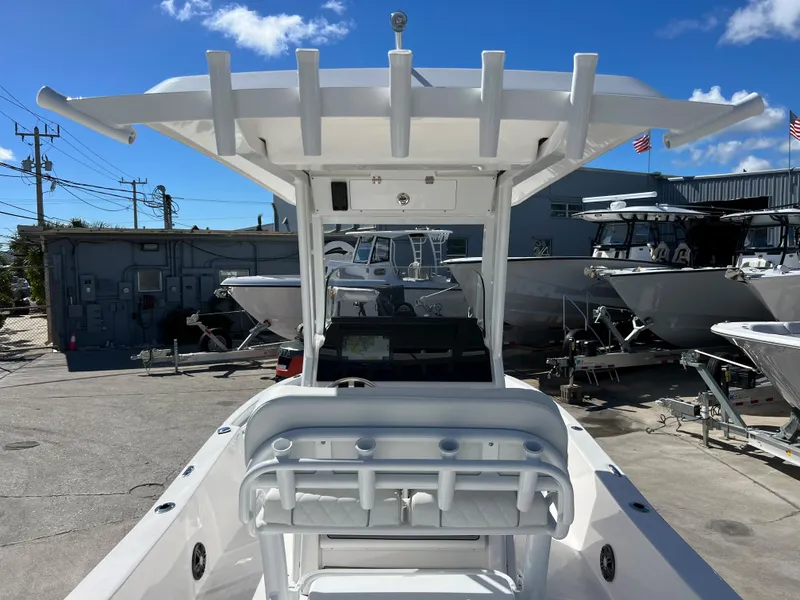 Slide: The Image of 2024 Sea Fox 251 Bay Fox boat with Yamaha engine, rear seating, and storage compartments. - 27