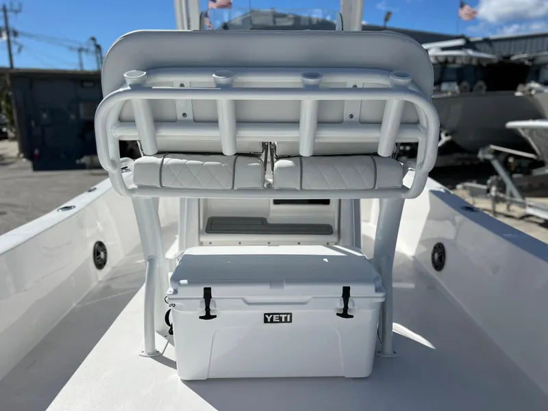 Slide: The Image of 2024 Sea Fox 251 Bay Fox boat stern with outboard motor and storage compartments. - 28