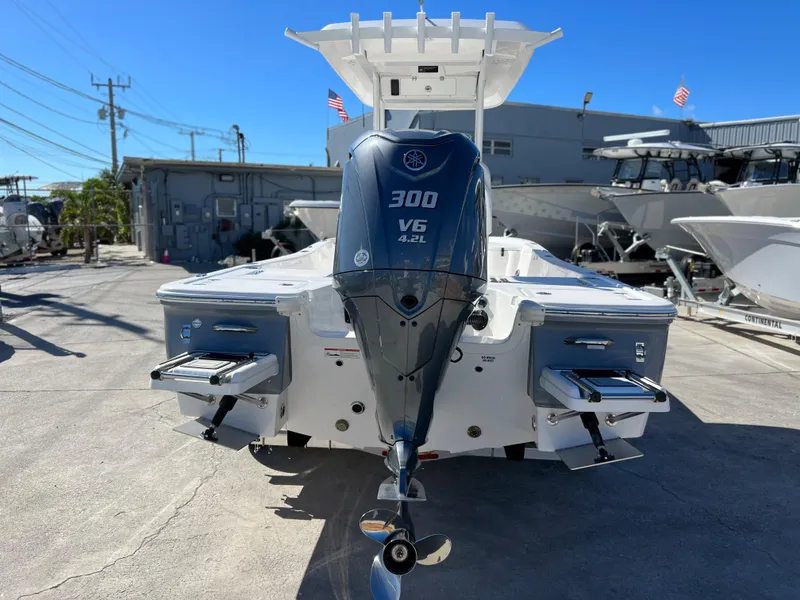 Slide: The Image of 2024 Sea Fox 251 Bay Fox boat on a Continental trailer, docked outdoors. - 3