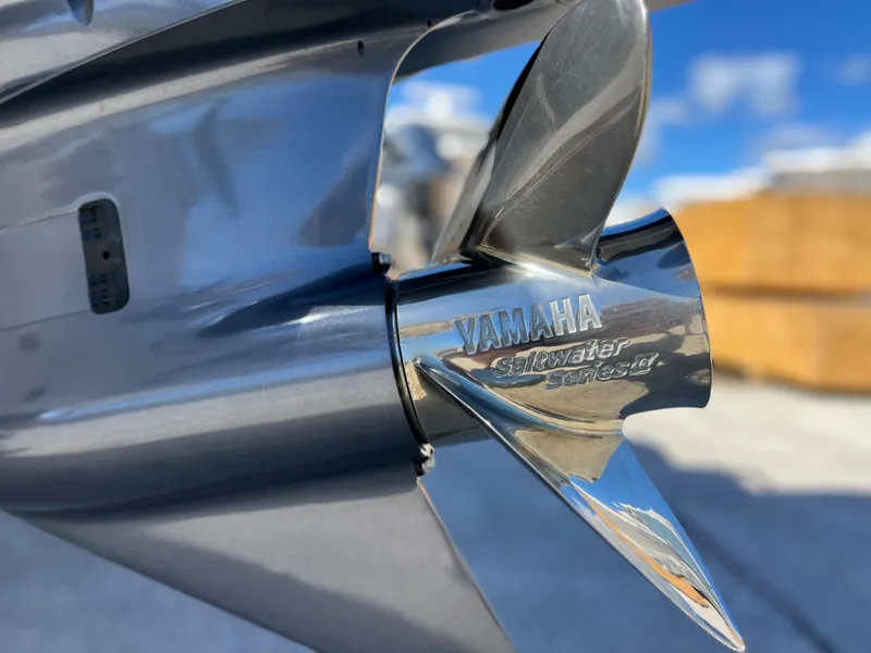 Slide: The Image of 2024 Sea Fox 251 Bay Fox boat with Yamaha engine, docked under a clear blue sky. - 39