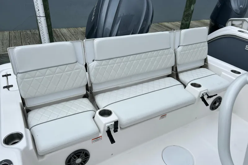 Slide: The Image of 2024 Sea Fox 251 Bay Fox boat seating with white cushioned upholstery and cup holders. - 45