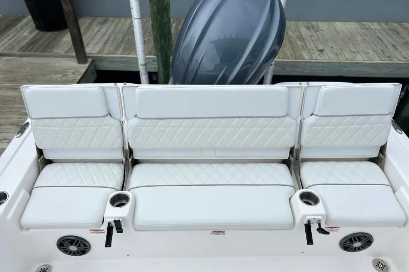 Slide: The Image of 2024 Sea Fox 251 Bay Fox boat with white cushioned seating and cup holders. - 46