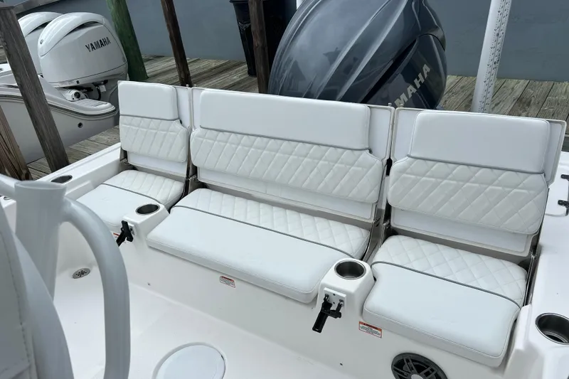 Slide: The Image of 2024 Sea Fox 251 Bay Fox boat with white cushioned seating and Yamaha outboard engines. - 47