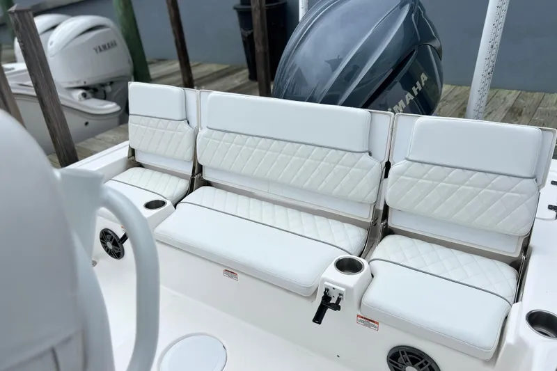 Slide: The Image of 2024 Sea Fox 251 Bay Fox boat with white cushioned seating and Yamaha engine. - 48