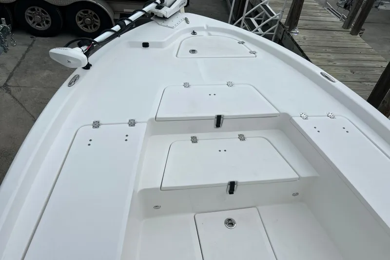 Slide: The Image of 2024 Sea Fox 251 Bay Fox boat deck with storage compartments and trolling motor. - 49
