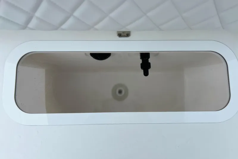 Slide: The Image of Livewell compartment on 2024 Sea Fox 251 Bay Fox boat, featuring a white interior. - 51