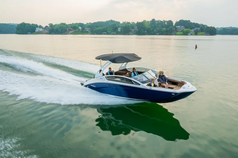 Slide: The Image of 2024 Yamaha Boats 275SE cruising on a lake with passengers. - 9