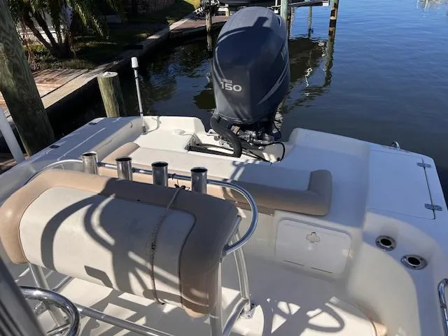Slide: The Image of 2007 Scout 220 Bay Scout boat with 150 HP outboard motor docked by the water. - 4