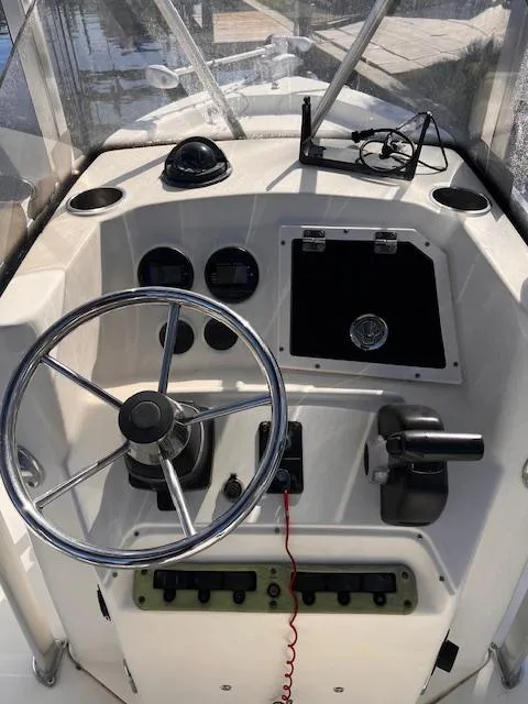 Slide: The Image of 2007 Scout 220 Bay Scout boat console with steering wheel and controls. - 5