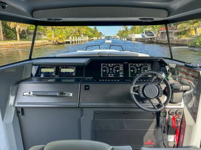 Slide: The Image of 2024 BRABUS Shadow 900XC cockpit with advanced navigation displays on a scenic waterway. - 10