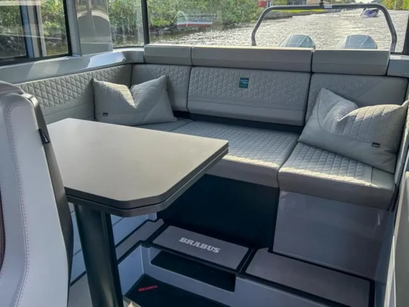 Slide: The Image of Luxurious interior of 2024 BRABUS Shadow 900XC with quilted seating and sleek table. - 18