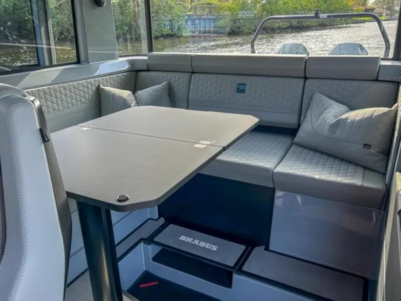 Slide: The Image of Luxurious interior of 2024 BRABUS Shadow 900XC with quilted seating and sleek table design. - 19