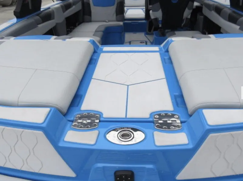 Slide: The Image of 2023 Malibu M220 boat interior with blue and gray seating. - 5