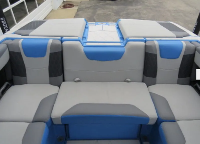 Slide: The Image of 2023 Malibu M220 boat interior with blue and gray seating. - 9
