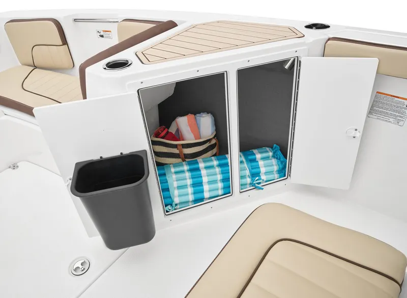 Slide: The Image of Storage compartments on the 2024 Yamaha Boats 222 FSH Sport, with towels and a basket. - 6