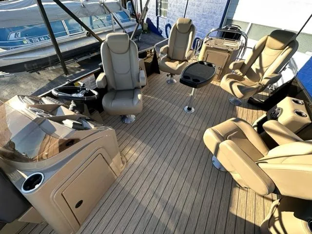 Slide: The Image of 2024 Starcraft EXS-3 HB4 boat interior with beige seating and wooden flooring. - 2