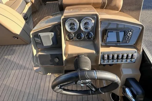 Slide: The Image of 2024 Starcraft EXS-3 HB4 boat dashboard with steering wheel, gauges, and control panel. - 4