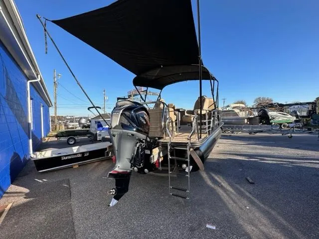 Slide: The Image of 2024 Starcraft EXS-3 HB4 pontoon boat with canopy in a marina. - 5