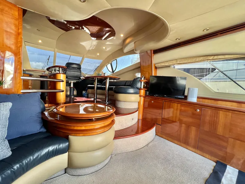 Slide: The Image of Luxurious interior of a 2004 Azimut 55E yacht with elegant wood finishes and modern amenities. - 21