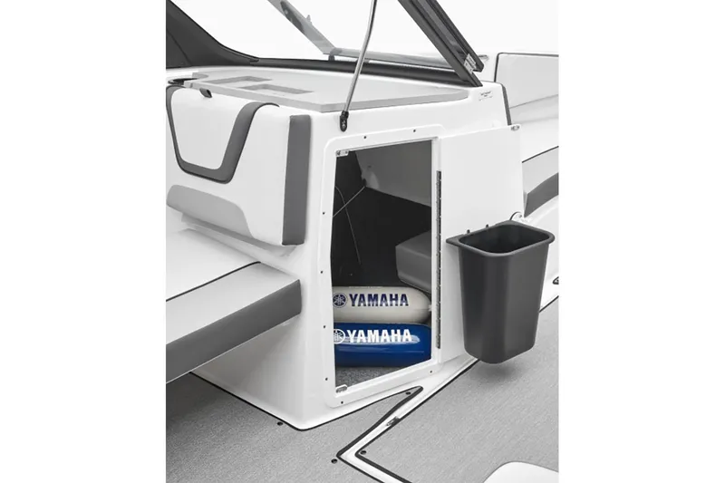 Slide: The Image of 2024 Yamaha Boats SX220 storage compartment with Yamaha-branded items. - 6