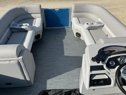 Slide: The Image of 2024 Sweetwater 2286SBCX pontoon boat interior with gray seating and modern dashboard. - 10