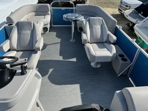Slide: The Image of 2024 Sweetwater 2286SBCX pontoon boat interior with plush seating and modern design. - 11