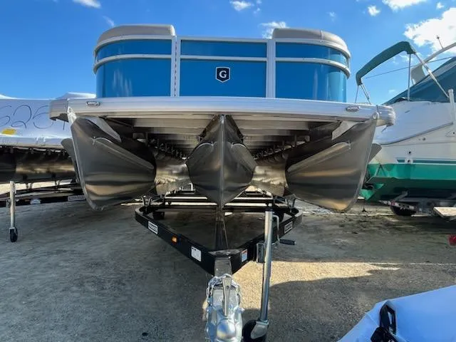 Slide: The Image of 2024 Sweetwater 2286SBCX pontoon boat on trailer, front view. - 2